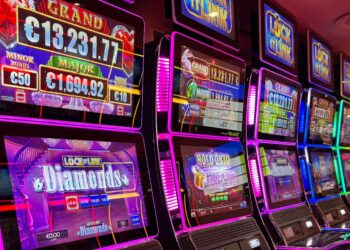 An array of slot machines lined up against each other in the casin